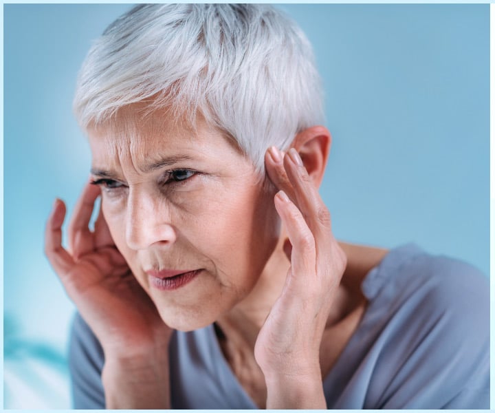 Woman in discomfort from ringing in her ears